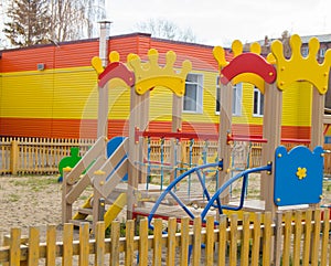 Colorful children& x27;s Playground in the sun, a Playhouse and a slide