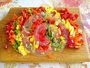 colorful chili peppers on wooden plate