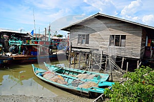 Colorful chinese fishing boat resting at a Chinese Fishing Village- Sekinchan, Malaysia