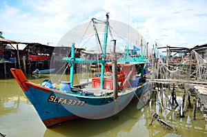 Colorful chinese fishing boat resting at a Chinese Fishing Village- Sekinchan, Malaysia