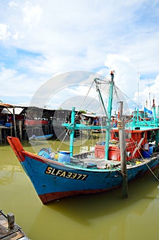 Colorful chinese fishing boat resting at a Chinese Fishing Village- Sekinchan, Malaysia