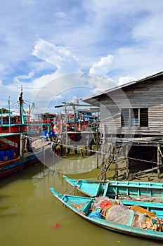 Colorful chinese fishing boat resting at a Chinese Fishing Village- Sekinchan, Malaysia