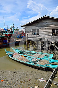 Colorful chinese fishing boat resting at a Chinese Fishing Village- Sekinchan, Malaysia