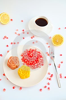 Colorful Chinese mooncakes and coffee with white background