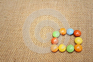 Colorful of chocolate on brown background