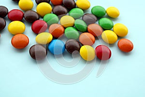 Colorful chocolate candies on color background, small candy mix