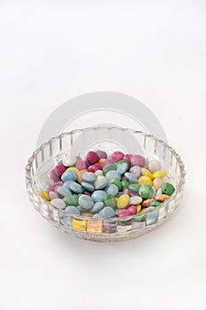 Colorful chocolate candies in a crystal bowl