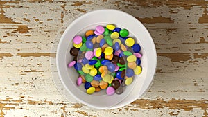 Colorful chocolate candies falling down. 3D animation of colorful chocolate candies swirling across the camera and falling