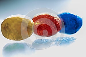 Colorful chocolate Easter eggs sitting in a row on a white background