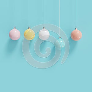 Colorful Christmas ball ornaments hanging on blue background