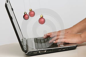 Colorful Christmas balls decorations and laptop