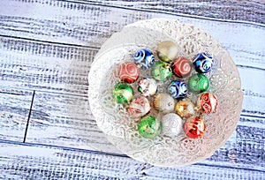 Colorful Christmas balls in white bowl