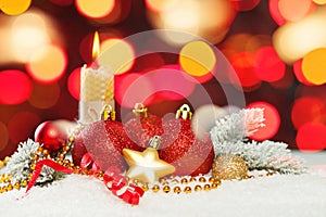 Colorful Christmas card with bokeh light, red ribbon, green fir branch, garland, baubles and white snow