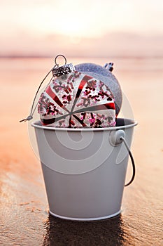 Colorful christmas decoration on the beach at sunset time, holiday concept