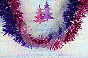 Colorful christmas photography image of christmas decoration hanging up of pink glitter xmas trees wrapping paper background