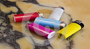 Colorful cigarette lighters on marbl