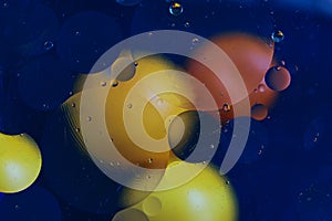 Colorful circles on the blue background, abstract texture for design purposes. Oily drops on the water