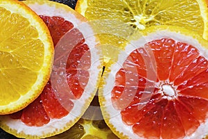 Colorful citrus fruit - orange, grapefruit - slices background. Healthy food concept, natural vitamins, diet, vegetarian food