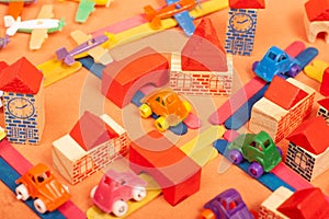 Colorful city on a orange background toys cars aeroplanes houses