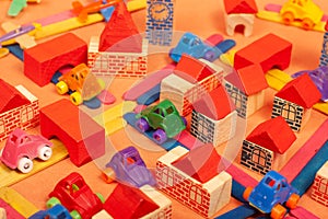 Colorful city on a orange background toys cars aeroplanes houses