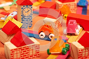Colorful city on a orange background toys cars aeroplanes houses