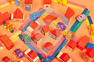 Colorful city on a orange background toys cars aeroplanes houses