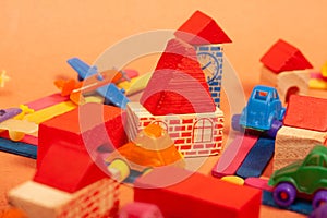 Colorful city on a orange background toys cars aeroplanes houses