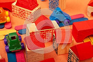 Colorful city on a orange background toys cars aeroplanes houses