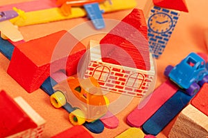Colorful city on a orange background toys cars aeroplanes houses