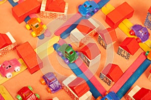 Colorful city on a orange background toys cars aeroplanes houses