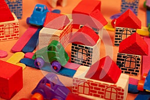 Colorful city on a orange background toys cars aeroplanes houses