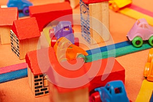 Colorful city on a orange background toys cars aeroplanes houses