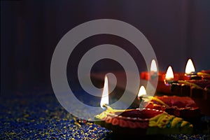 Colorful clay diya lamps lit during Diwali celebration