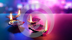 Colorful clay diya lamps lit during diwali celebration