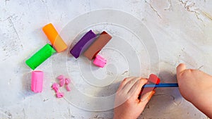 Colorful clay plasticine, modelling clay pieces with child`s hands, horizontal, education, child psychology