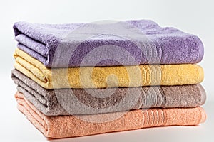 Colorful clean cotton towels isolated on white.