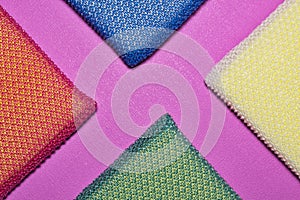 Colorful cleaning sponges arranged in triangle diagonals.