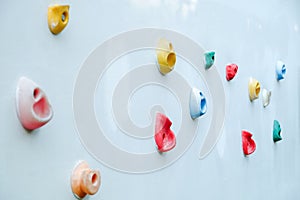 Colorful climbing holds on wall