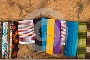 The colorful clothes hang on the rope for sales