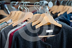 Colorful clothes hang on shelf in a market