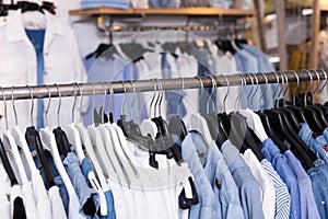 Colorful clothes hanging on hangers in the fashion store