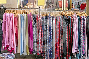 Colorful clothes hanging on racks