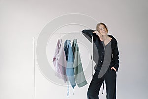 Colorful clothes Hanging on a White Metal Rack Against a Neutral Background