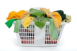 Colorful clothes in laundry basket. Green, yellow.