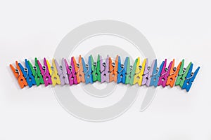 colorful clothes pegs isolated on white background