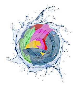 Colorful clothes rotates in a swirling splashes of water photo
