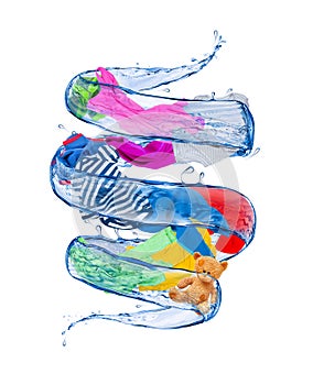 Colorful clothes rotates in a whirlpool of water photo