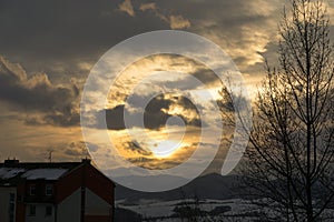 Colorful clouds over the city and buildings or park and meadow, during sunrise or sunset.