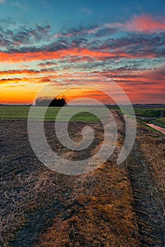 Colorful cloudy sky in the sunset time in Italian countryside