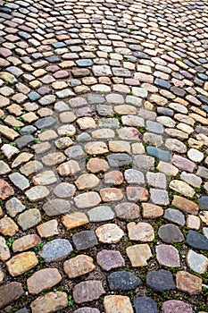 Colorful cobblestone pattern on old European cobbled street
